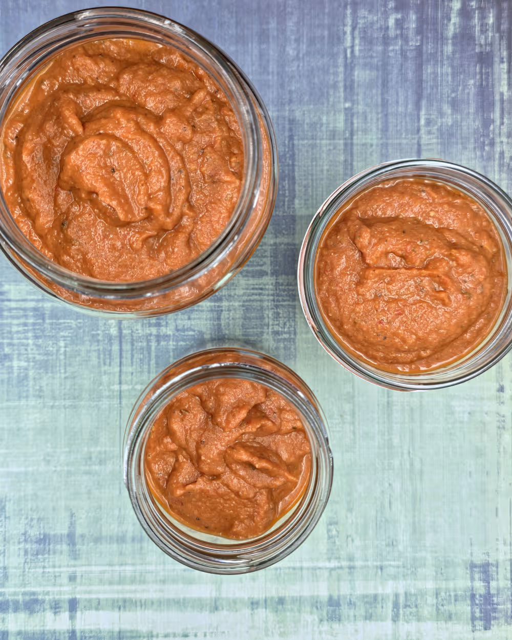 Pureed Ratatouille Pasta Sauce portioned into glass jars ready for fridge storage.