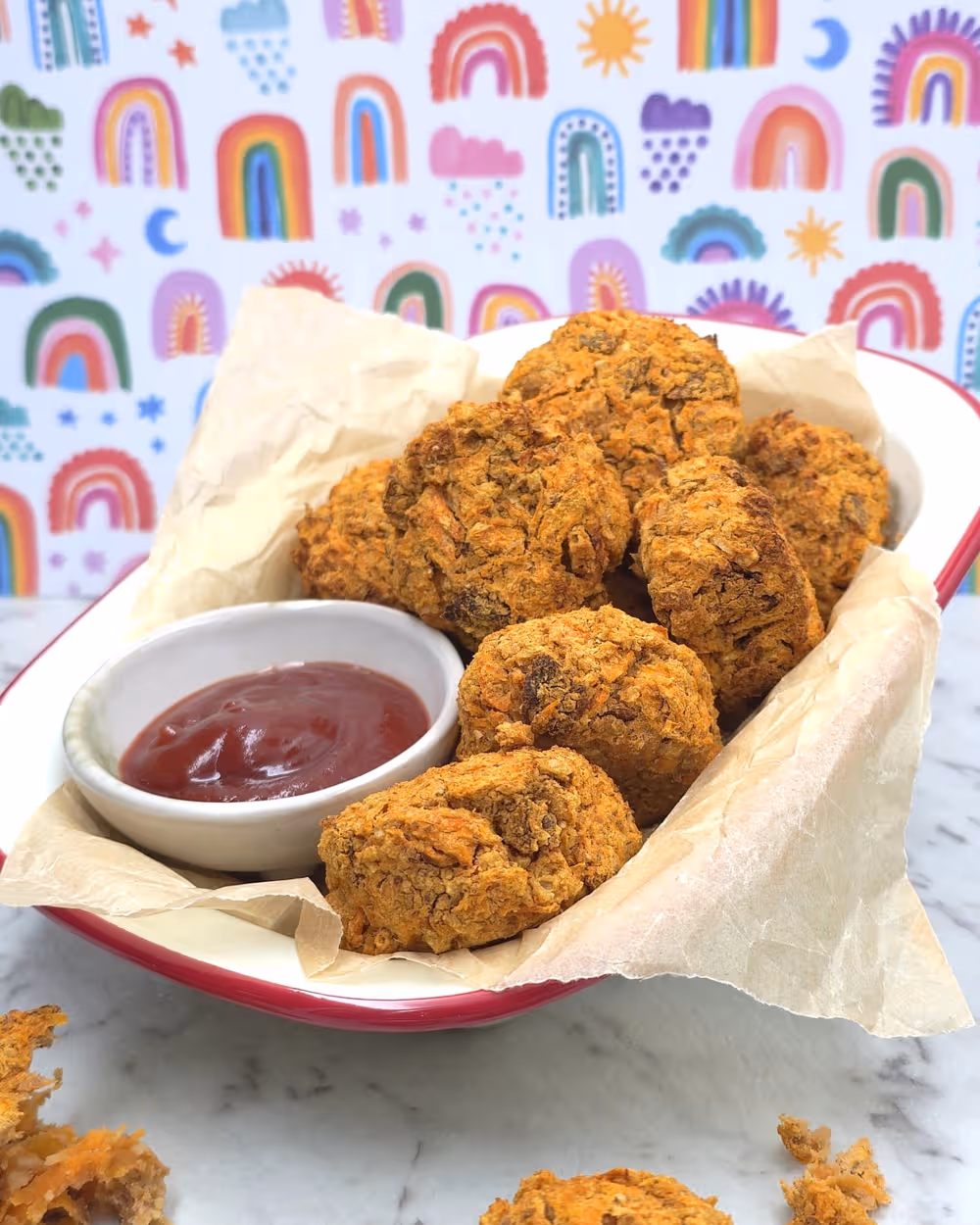 Crispy baked Veggie Nuggets served on a plate with a dipping bowl of tomato sauce.